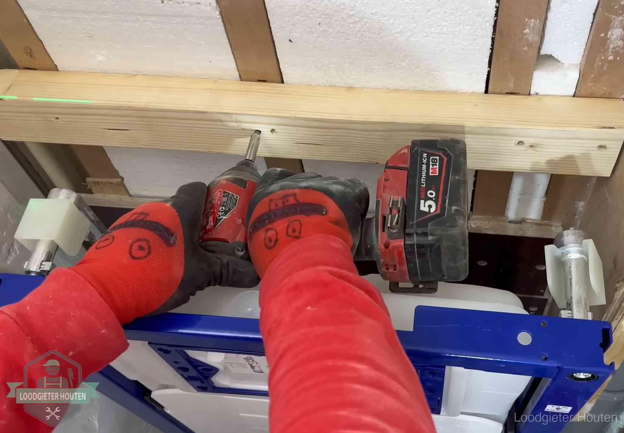 Fout in de wc-installatie opsporen in Houten Monteur bevestigt een inbouwreservoir voor een hangend toilet in Houten